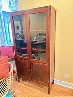 Front view of rosewood hutch showing glass doors and lower paneled doors