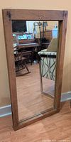 Front view of rectangular wood-framed mirror