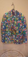 Front view of multicolour Super Mario print suit jacket and tie on hanger