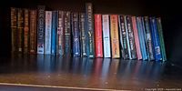 Full shelf of 22 Sue Grafton novels A–V