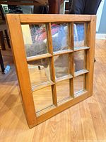 Front view showing entire nine-pane mirror and wood frame