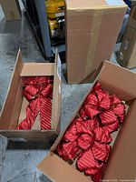Two cartons containing multiple red striped bows