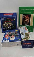 All four boxed Christmas light decorations grouped