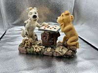 Front view of ceramic figurine showing both dogs and checkerboard