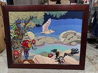 Full view of framed needlepoint scene