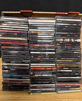 Box with over 100 CD jewel cases stacked