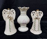 Front view of two Lenox angel bells and Belleek Lotus Blossom vase