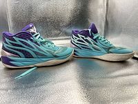 Side profile of both sneakers showing colorway and overall condition.