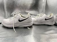 Side view of both shoes showing uppers, swoosh logos and general condition