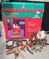 Overall lot showing Snoopy sculpture box, sleigh bells, lights, elf, noise makers