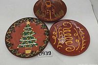 Group shot of three redware plates displaying front designs