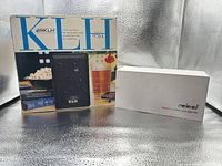 KLH 970A boxed speakers beside boxed Melorell speakers