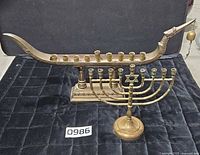 Both brass menorahs together showing scale and overall design