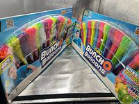 Both sealed boxes angled to show front graphics and quantity