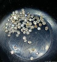 Pile of small round white diamonds in dish