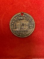 Obverse showing log cabin and inscriptions