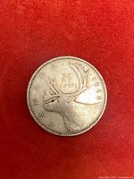 Reverse of 1944 Canada 25 cent silver coin showing caribou and date