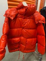 Front view red puffer jacket on hanger