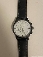 Front view of wristwatch showing dial, case and strap