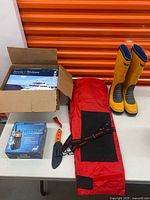 Overview of boots, radio box, knife, overalls bag and manuals