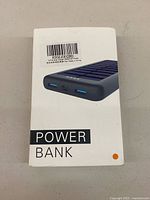 Retail box showing image of solar power bank with ports visible and barcode label