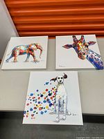 All three square animal canvas prints on table