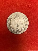 Reverse of 1895 sixpence showing crown, denomination and wreath