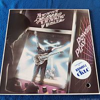 Front cover showing album art and promo sticker