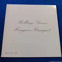 Front cover with cream background and scripted album title