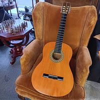 Full frontal view of guitar showing body, neck, bridge, strings