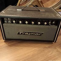 Front view of Traynor Bass Master amp head showing logo, grille cloth, control panel and handle