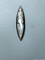 Front view of elongated mother-of-pearl cameo cabochon