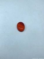 Top view of oval polished carnelian cabochon