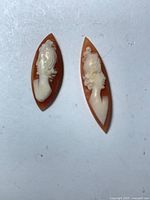 Front view of both marquise shell cameos showing female profiles