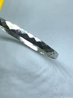 Side view showing faceted pattern on silver band