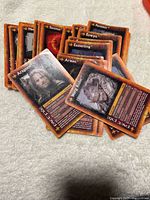Pile of character face cards including Aragorn and Sharku showing fronts