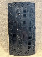 Full view of carved black cribbage board front