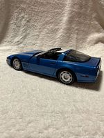 Passenger-side rear three-quarter view of blue Corvette model