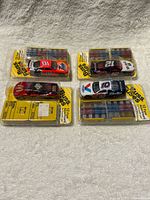 Four Buss Fuse promotional die-cast cars in packaging