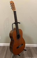 Front angled view of Suzuki #700 classical guitar on stand
