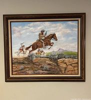 Frontal view of signed western painting in frame