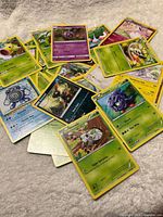 Spread of assorted Pokémon cards showing several card faces