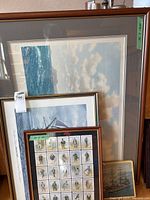 Stack showing seascape, sailboat print, Dickens card collage, and tall-ship painting