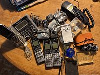 Entire lot showing phones, binoculars, paperweight and accessories