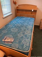 Full view of twin captain bed with mattress in place