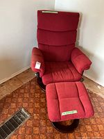 Full view of red swivel recliner chair with ottoman on wood ring base