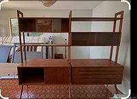 Assembled view of two-bay teak wall unit showing shelves, sliding-door cabinet and drawer cabinet