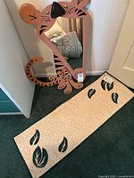 Tiger-shape decorative mirror and cotton runner displayed on floor