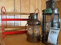 Two lanterns and ribbon rack on shelf