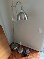 Floor lamp, small lamp base, and black desk lamp grouped in corner